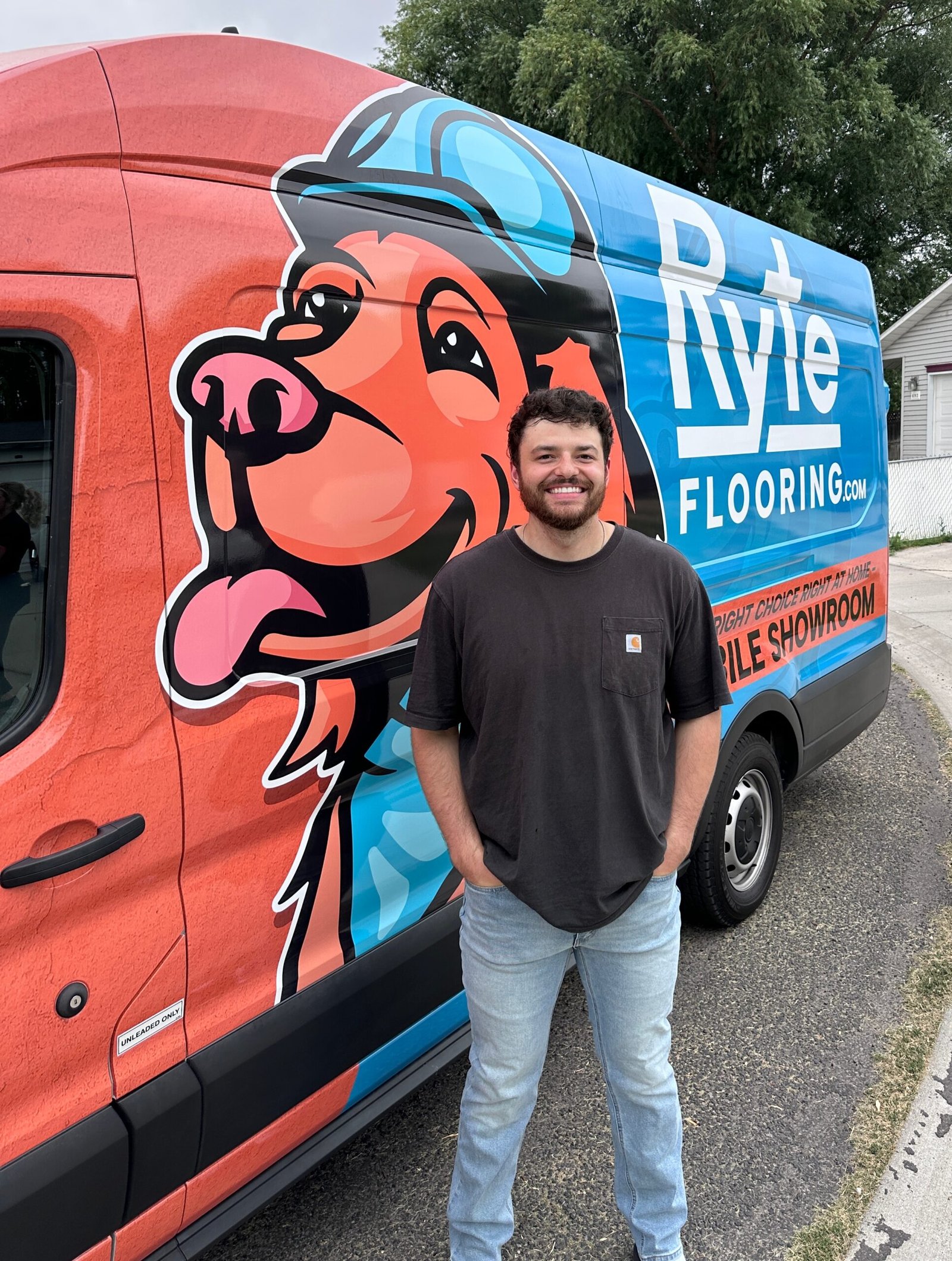Client Photo A happy client posing in front of Ryte Flooring mobile showroom after a successful flooring project.