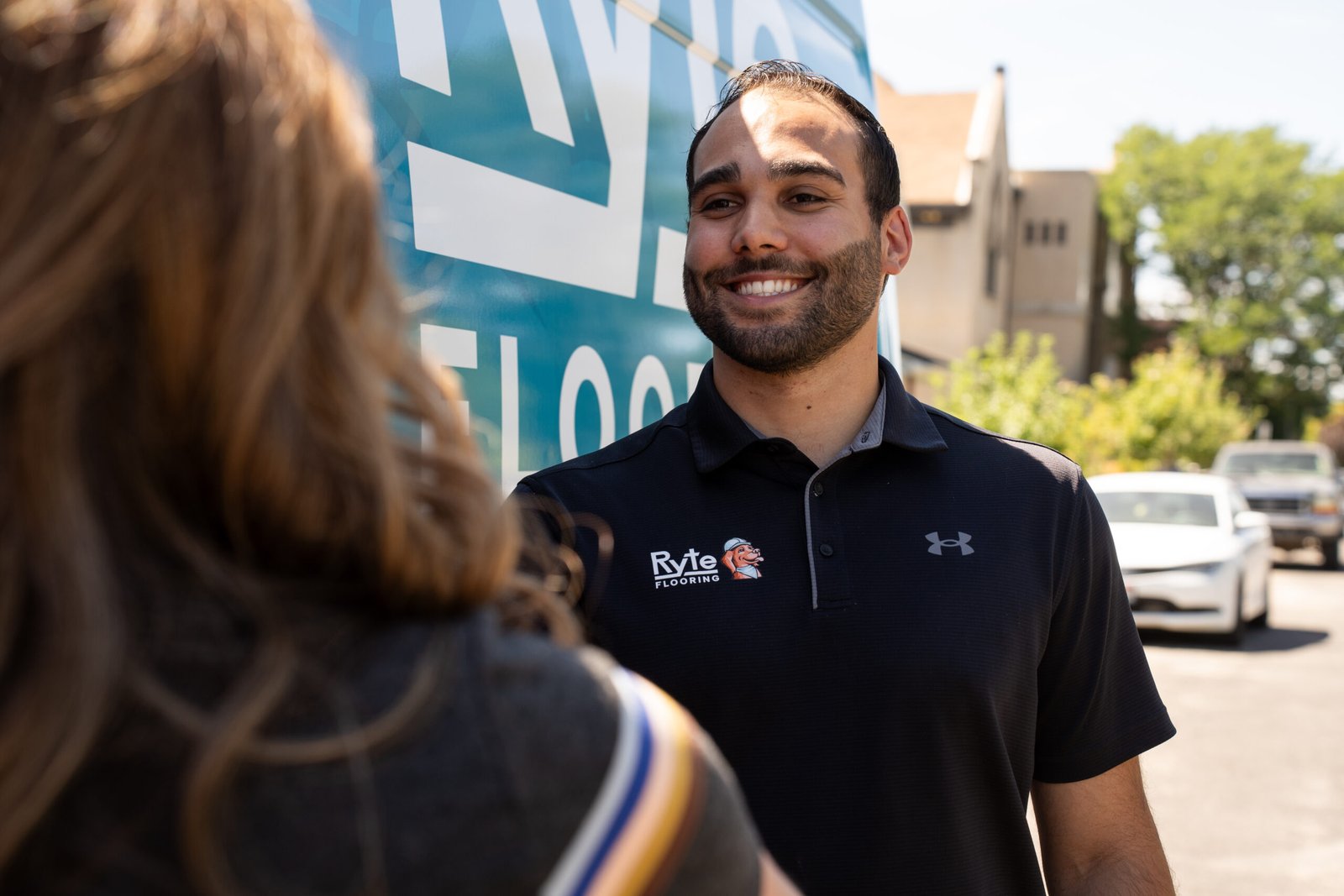 Flooring professional greeting a customer.