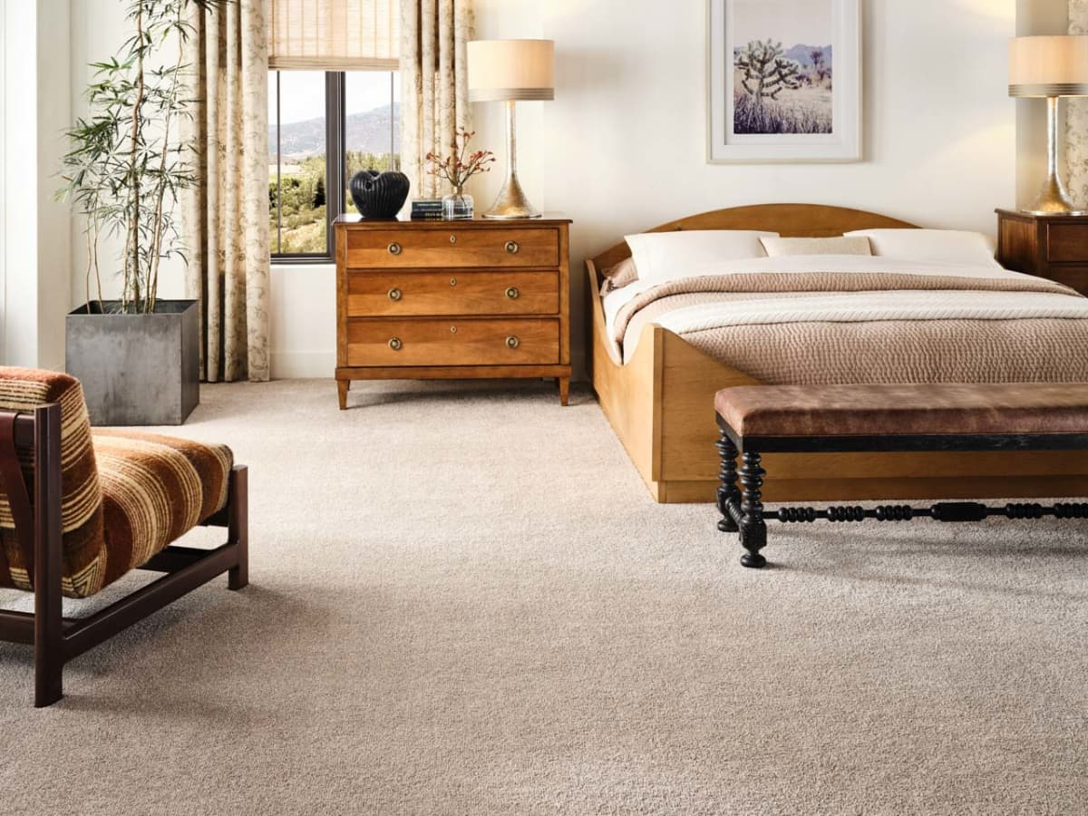 Modern open-concept living room with grey patterned loop carpet.